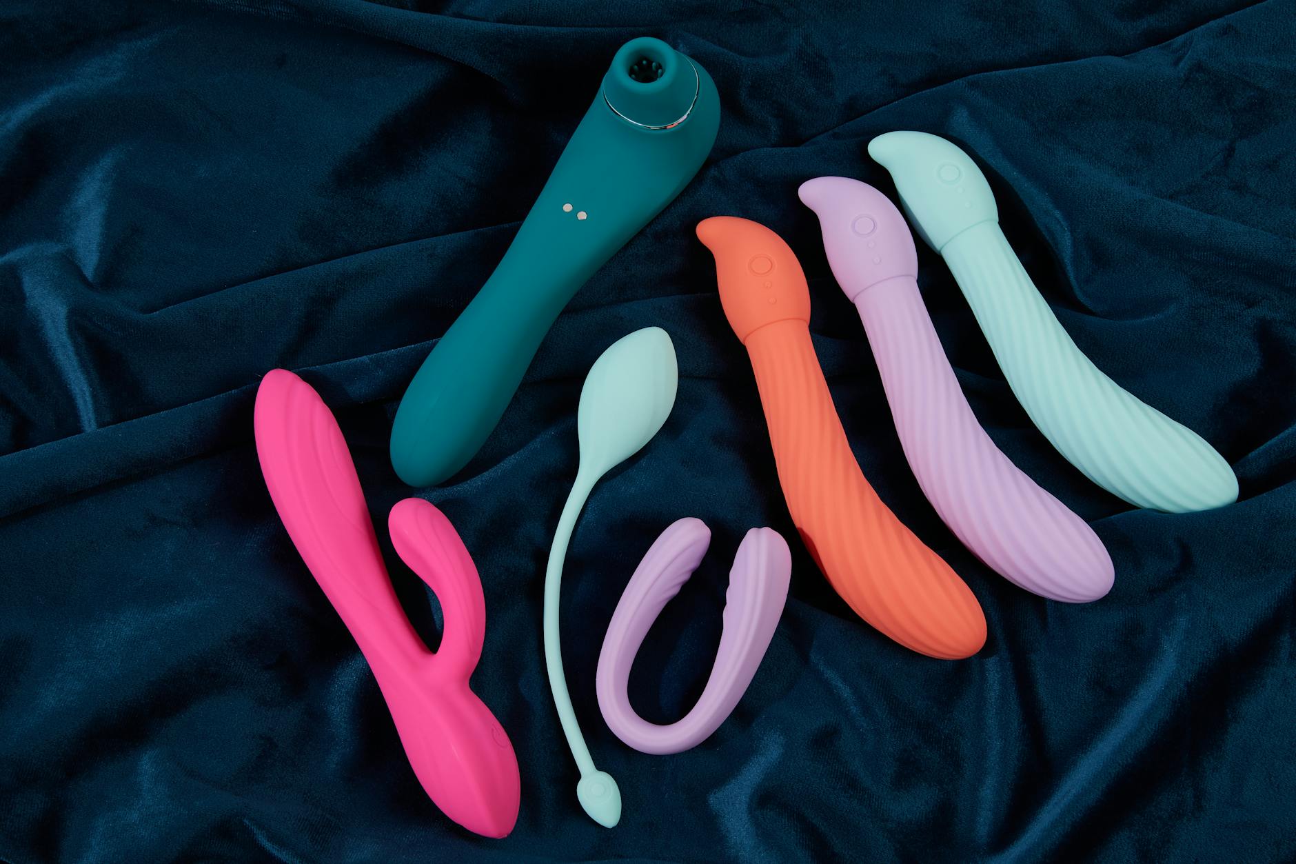 A couple holding a blue vibrator together, symbolizing intimacy and shared conversation about pleasure