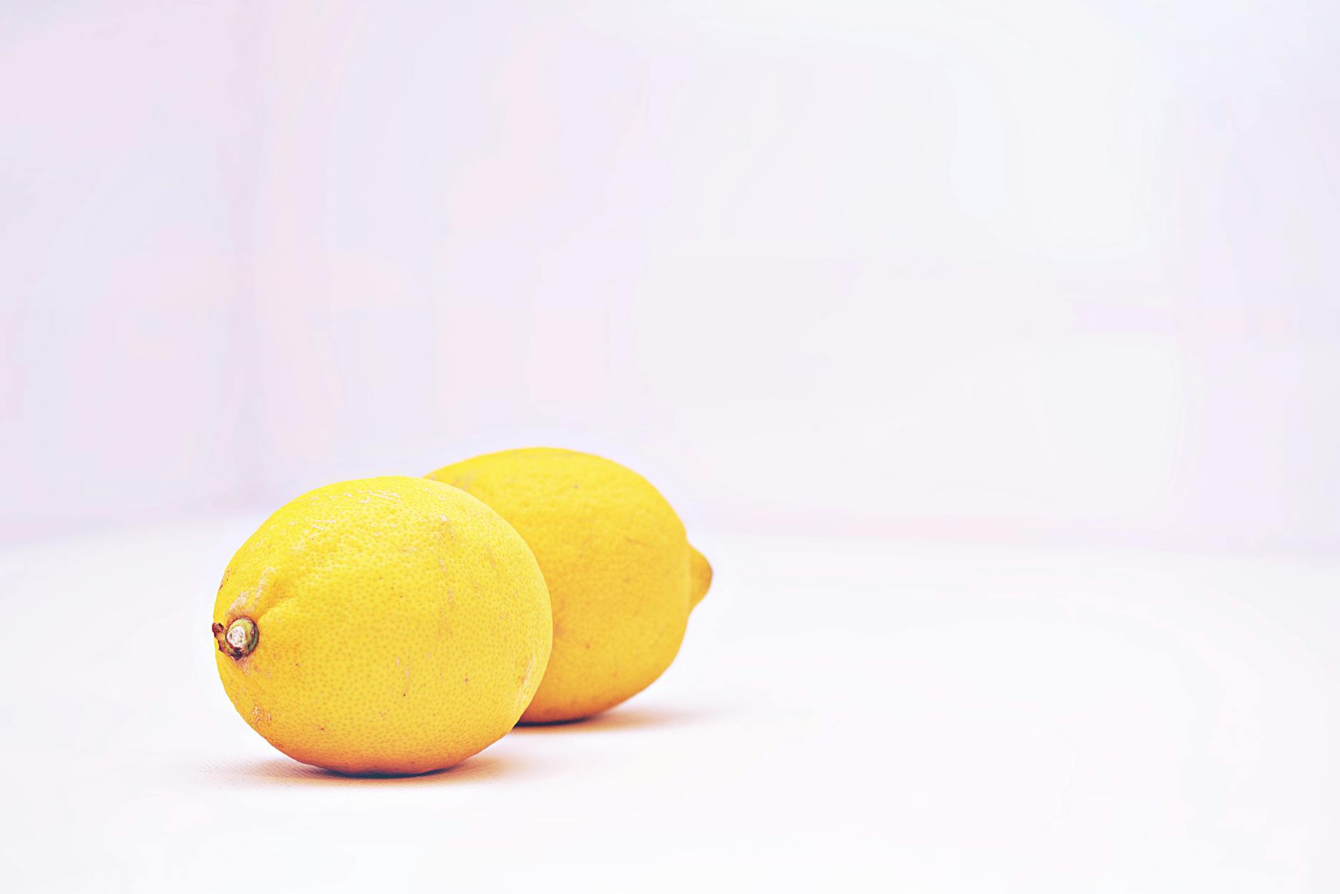 Fresh lemons on a white background symbolizing sensitivity and careful touch
