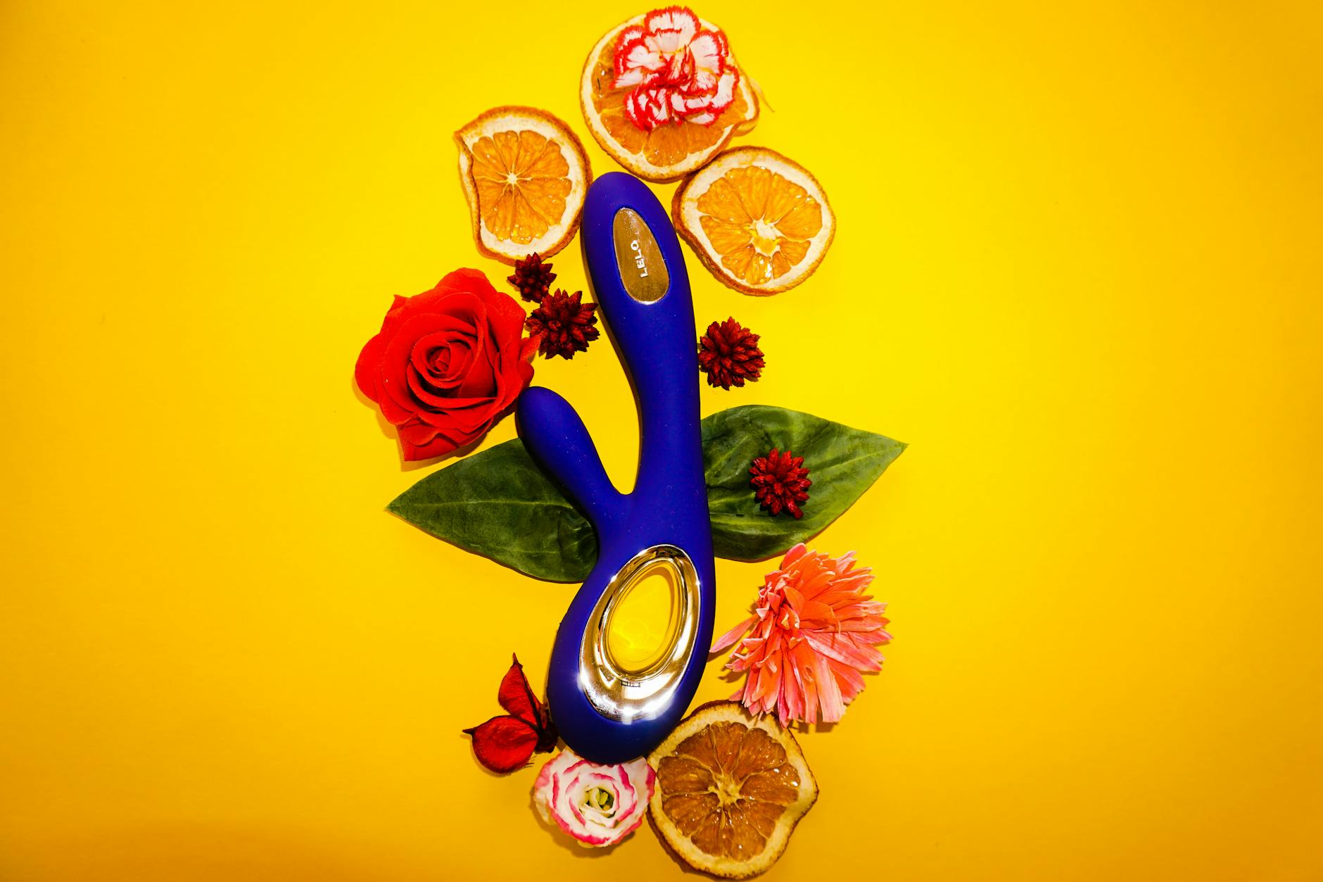 Hands reaching toward a colorful array of adult toys on a table, representing choice and partnership exploration